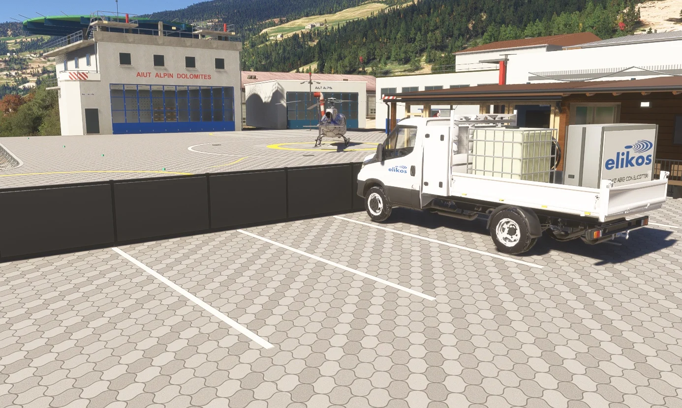 Elikos service truck parked beside the apron and entrance gates.